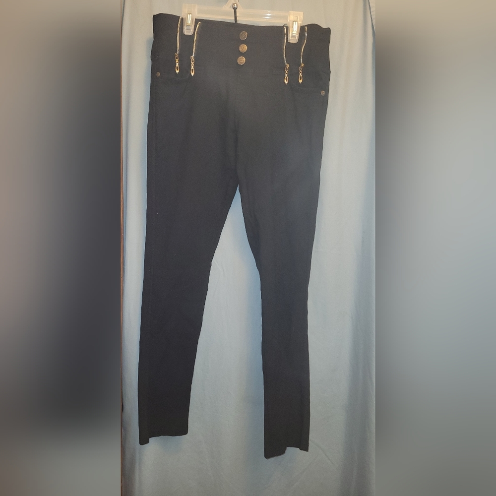 Black stretch ankle-length jeggings with accessorized buttons & zippers.